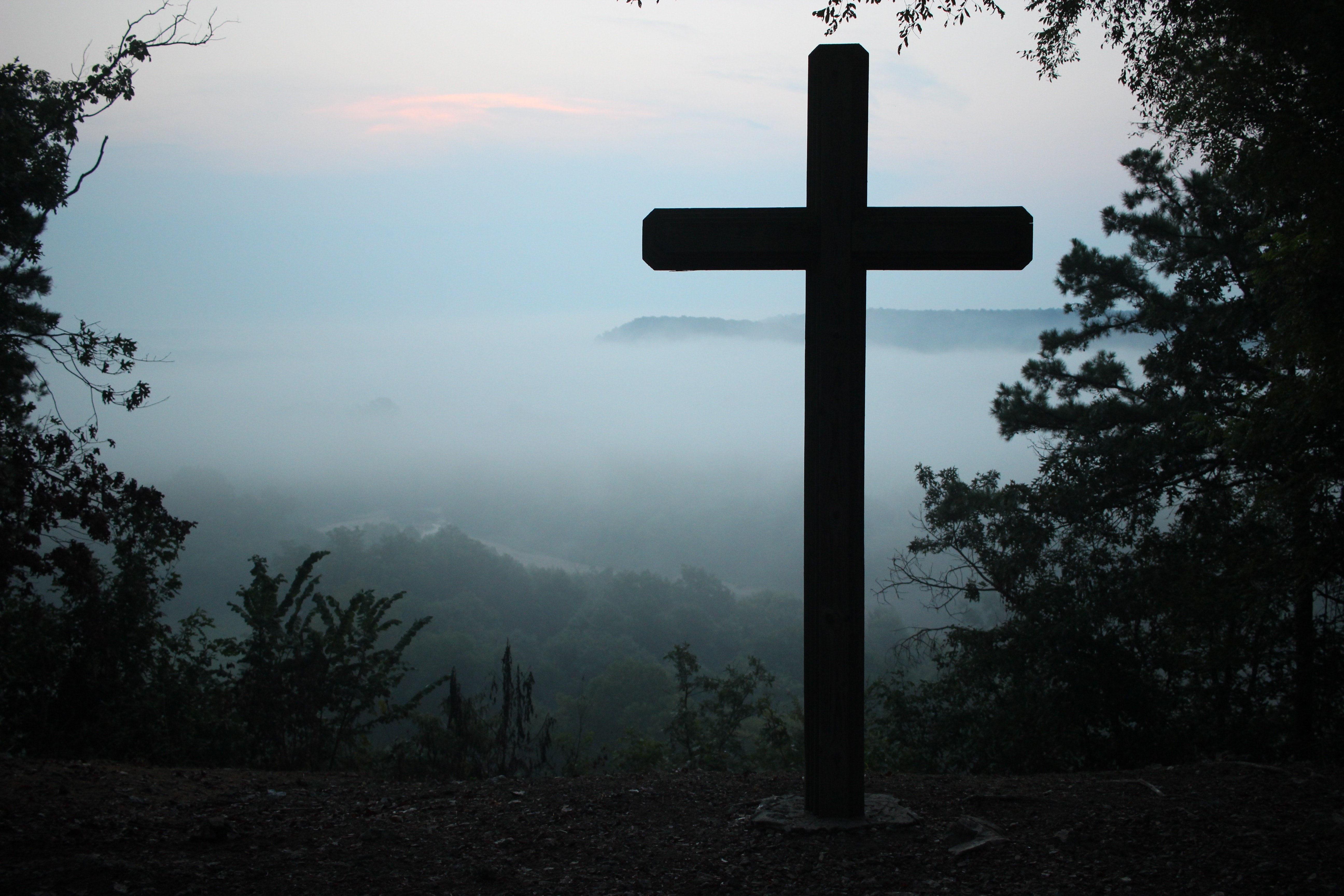 Cross Silhouetted on Mountain