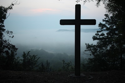 Cross Silhouetted on Mountain