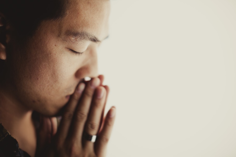 Asian man praying