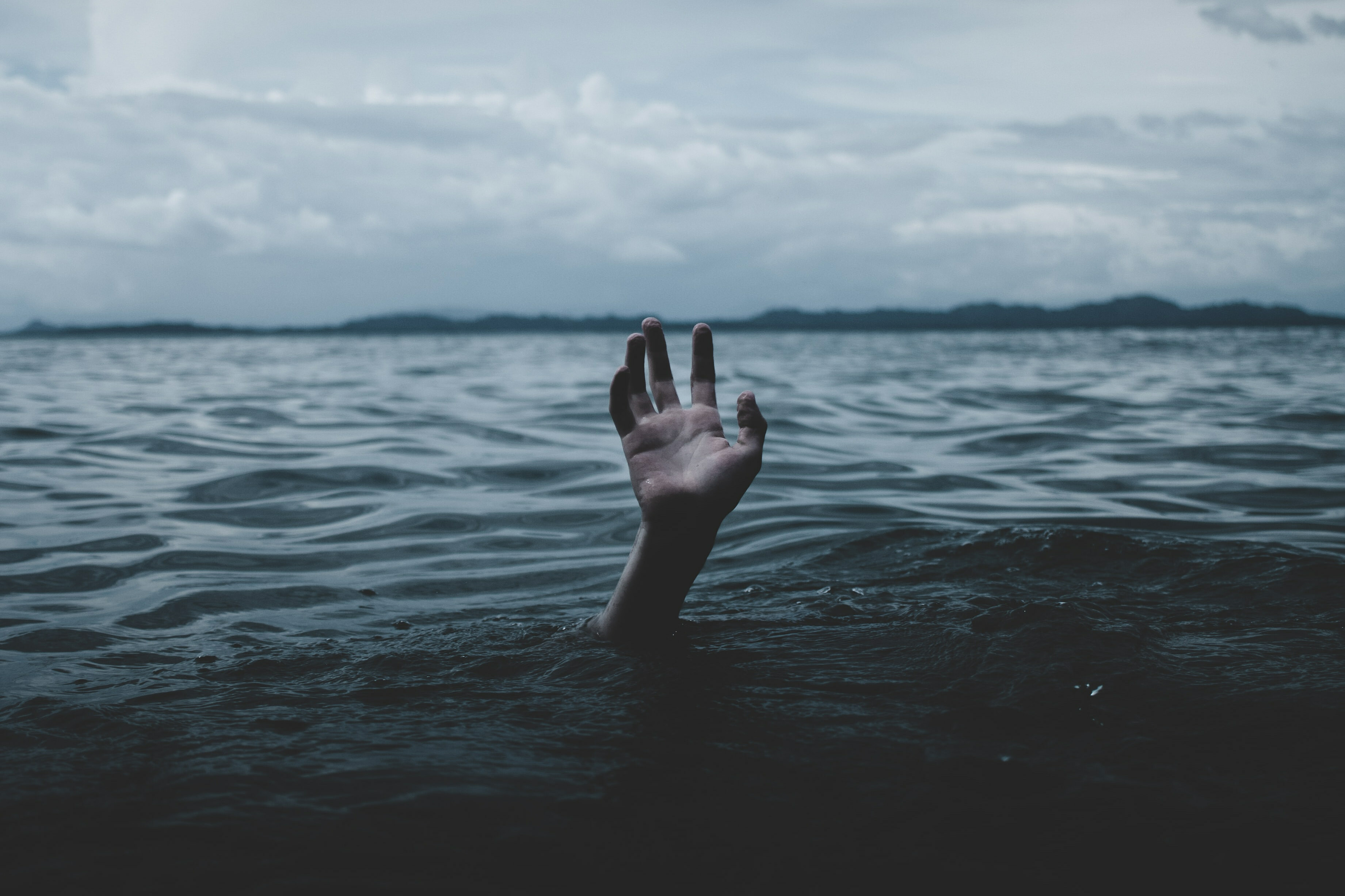 Drowning hand reaching up