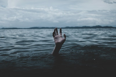 Drowning hand reaching up