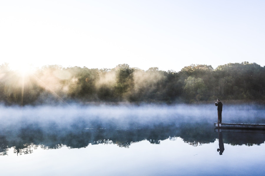 Man Reflecting Over Morning Lake