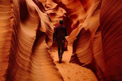 Man walking through red canyon